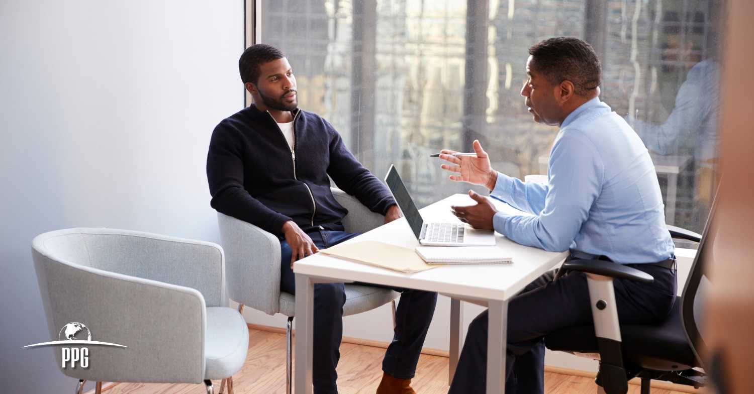 Two men talking in office